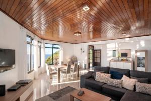 a living room with a couch and a table at Casa Coelho in Ponta do Sol