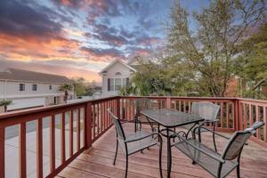 a patio with a table and chairs on a deck at Spacious House with Pool near the Beach 2165 in Myrtle Beach