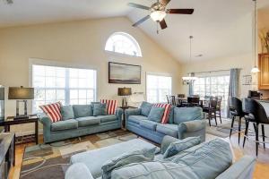 a living room with blue couches and a dining room at Spacious House with Pool near the Beach 2165 in Myrtle Beach