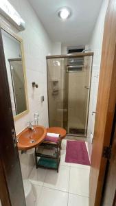 a bathroom with a shower and a sink and a toilet at Copacabana, confortável apto de 2 quartos, quadra da praia in Rio de Janeiro