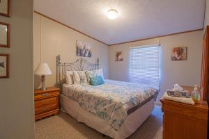a bedroom with a bed and a dresser and a window at Stay In Ohiopyle near the GAP Trail - Ohiopyle, PA in Ohiopyle