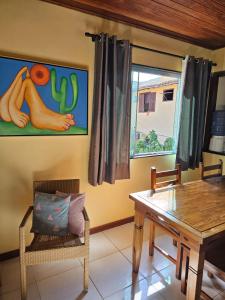 a dining room with a table and a window at Apartamento Buziano in Búzios