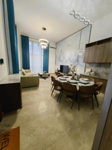 a kitchen and living room with a table and chairs at Xtu Golf Villa Forest City五房独栋别墅 in Kampong Tiram Duku