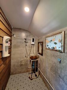 a bathroom with a shower and a sink at Pai Chao Kha in Pai