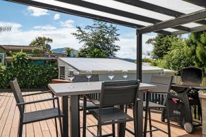 a patio with a table and chairs on a deck at Whare 35 - Rotorua Holiday Home in Rotorua