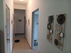 a hallway with a door and a hallway with plates on the wall at Melinjau Homestay Putrajaya for Islamic Friendly in Putrajaya