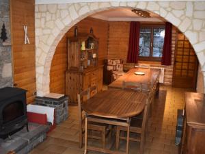a dining room with a wooden table and a stove at Chalet Font-Romeu-Odeillo-Via, 6 pièces, 12 personnes - FR-1-580-103 in Font-Romeu-Odeillo-Via