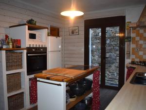 a kitchen with a white refrigerator and a microwave at Chalet Font-Romeu-Odeillo-Via, 6 pièces, 12 personnes - FR-1-580-103 in Font-Romeu-Odeillo-Via