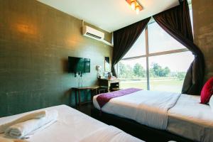 A bed or beds in a room at Anggun Hotel