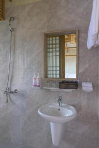 a bathroom with a sink and a mirror at K-Town Resort Phan Thiet in Phan Thiet
