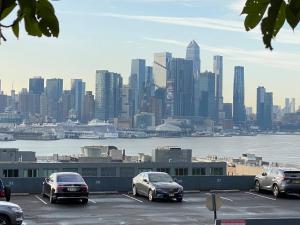 a parking lot with cars parked in front of a city at 1 New York City, The Best Gateway Vacations in North Bergen