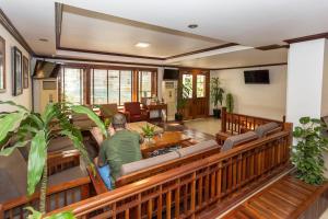 a man sitting in the sanctuary of a church at Cheathata CTA Hotel Siem Reap in Siem Reap