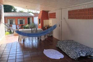 a balcony with a hammock in a house at Aconchego Lar Cama e Café in Foz do Iguaçu