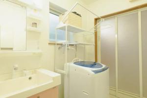 a bathroom with a sink and a toilet and a mirror at ファミリア・デザインハウス札幌 in Sapporo +22 photos