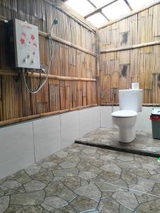 a bathroom with a toilet and a shower at Wanagiri Campsite in Gitgit