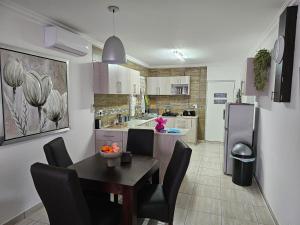a kitchen with a table and chairs and a dining room at Déjàvu at the Bay in Richards Bay