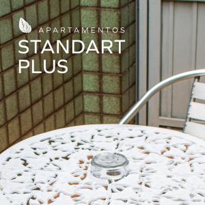 a white table with a sign that reads standant plus at Bela Vista Hotel in Arujá