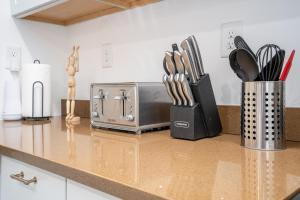a kitchen counter with a toaster and utensils at Centrally Located 3BD Urban Oasis in Indianapolis