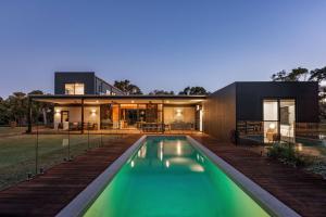 a house with a swimming pool in front of it at Eagle Rise Plus Studio in Dunsborough