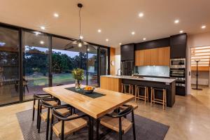a kitchen and dining room with a wooden table and chairs at Eagle Rise Plus Studio in Dunsborough