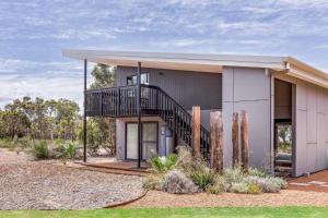 a house with a staircase on the side of it at Eagle Rise Plus Studio in Dunsborough