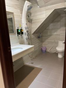 a bathroom with a sink and a toilet at Sunny Sky Homestay in Yujing