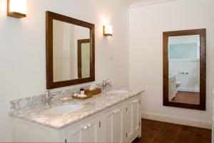 a bathroom with two sinks and a mirror at The Atlantis Historic Inn in Saint Joseph