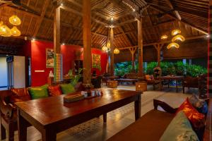 a living room with a wooden table and chairs at Ubud Heaven Sayan in Ubud