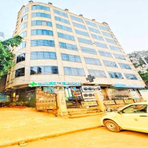 a building with a car parked in front of it at Hotel Air Stay Inn - Andheri East in Mumbai