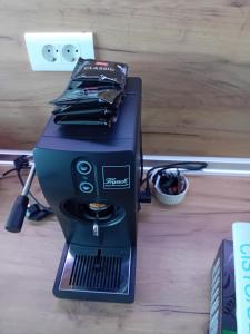 a black sewing machine sitting on a wooden floor at Vučko II in Bjelašnica +3 photos