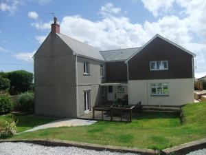 a house with a picnic table in front of it at The Count House in Saint Hilary