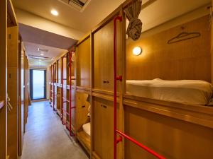 a row of bunk beds in a train room at Hotel Plus Hostel TOKYO ASAKUSA 2 in Tokyo