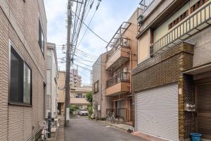 an alley between two buildings with a garage at Tokyo Skytree Residence Inn (F2) in Tokyo