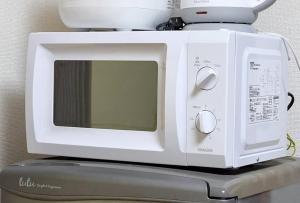 a white microwave sitting on top of a appliance at Tokyo Skytree Residence Inn (F2) in Tokyo