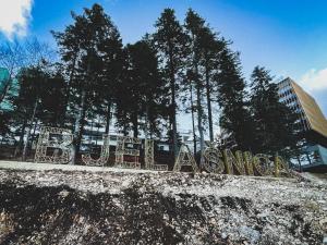 a sign on the side of a building with trees at Vučko II in Bjelašnica