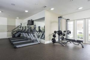 a gym with treadmills and machines in a room at Your 1Br and LR Home Away From Home in Dallas