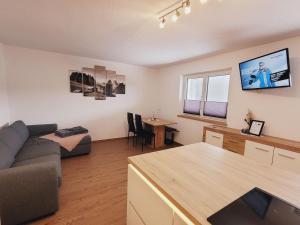 a living room with a couch and a table at New apartment in the beautiful Pitztal in Oberlehn