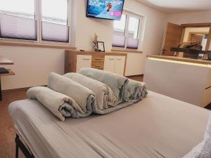 a room with a bed with towels on it at New apartment in the beautiful Pitztal in Oberlehn