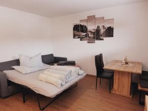 a living room with a table and a couch at New apartment in the beautiful Pitztal in Oberlehn