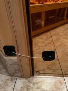 a cord plugged into a door in a room at Luxurious En-suit room with Sauna in Pyussi