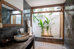 a bathroom with a sink and a window at Villa Loma by Alfred in Bali in Seminyak +27 photos