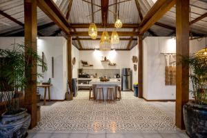 an open kitchen with a table in a room at Villa Loma by Alfred in Bali in Seminyak