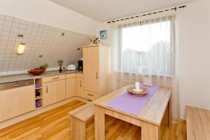 a kitchen with a table with a candle on it at NEU! Ferienwohnung zum Wiesenblick in Toppenstedt