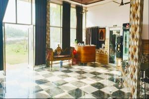 a living room with a checkered floor and a couch at Hotel O Sun Rahi in Purainī