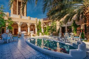 a courtyard with a swimming pool in front of a building at Arabian Boutique Hotel in Dubai