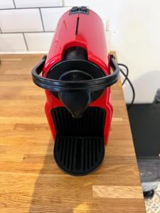 a red blender sitting on top of a wooden table at Mazot savoyard situé à 25 kms de CHAMONIX in Saint-Gervais-les-Bains