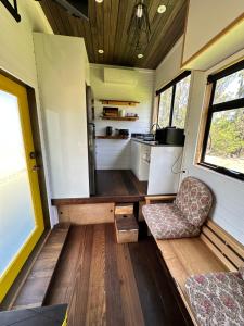 a tiny house with a kitchen and a living room at Ocean Breeze Tiny House - Ocean and Lake View in Mallacoota