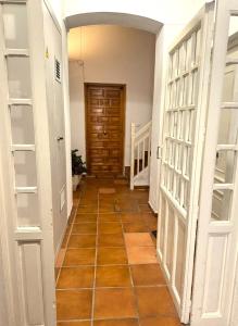 a hallway with white doors and a tile floor at Casa 1928 - 1 IZQ - Plaza de España in Seville