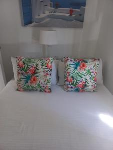 two pillows sitting on top of a bed in a room at 13 Bronze Bay in Durban