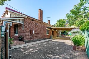 an old brick building with a brick driveway at Swainson on Church in Norwood